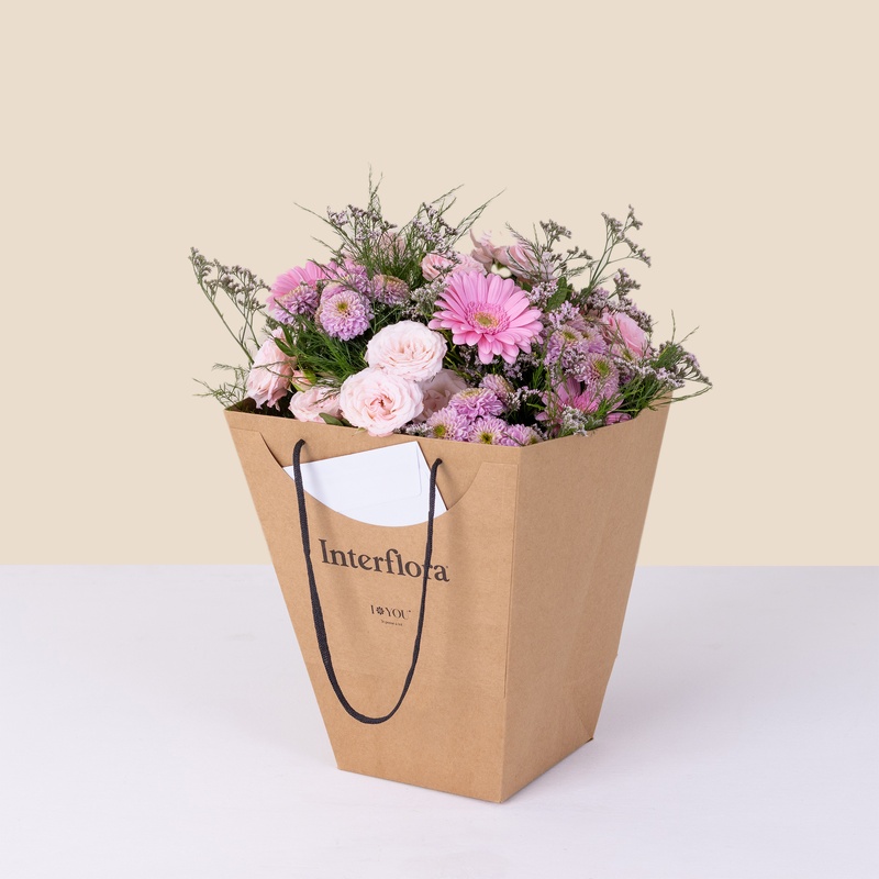 Bouquet rose pastel avec roses et germinis Interflora dans sac cadeau écoresponsable disponible sur bloomyrama