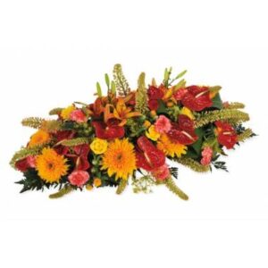 Composition de deuil orange rouge avec lys anthuriums et gerberas L'Agitateur Floral vu sur bloomyrama
